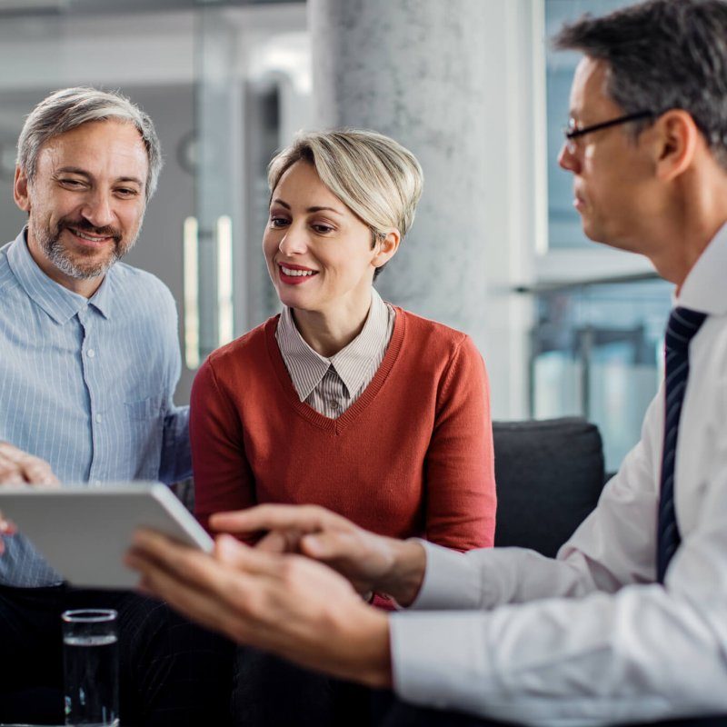 happy-mid-adult-couple-using-touchpad-with-their-financial-consultant-in-the-office--qjn5y4sdsqgl5ds6y84dr113mtmx9wwl6eh2dio280
